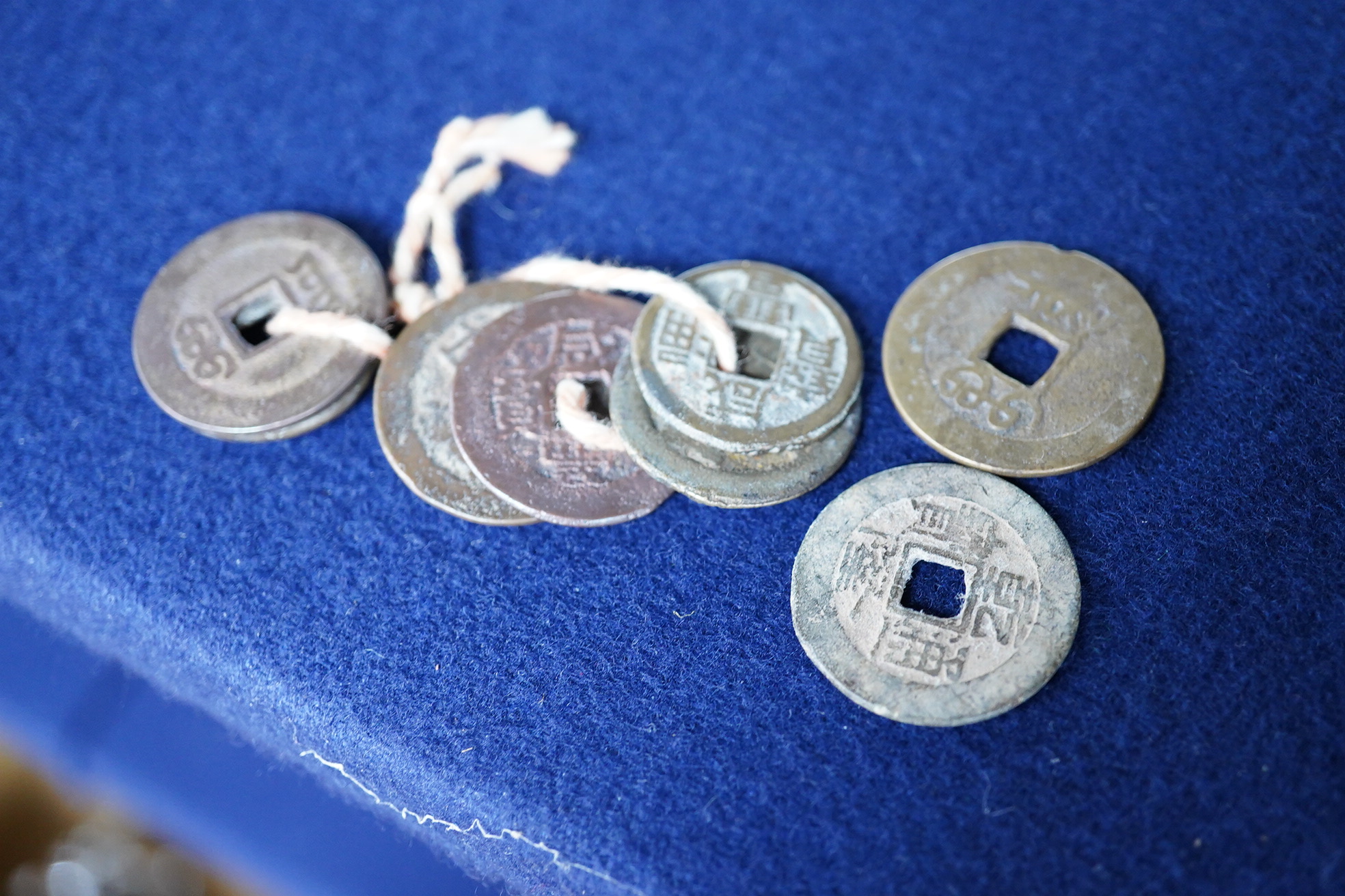 Chinese and Japanese coins, 16th to 20th century, including Chinese cast coins, Ming to Qing dynasty, Japanese Kan’ei Tsuho, in a rosewood box